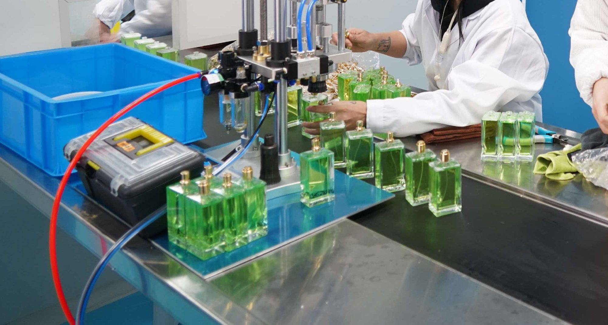 Perfume bottles on the assembly line